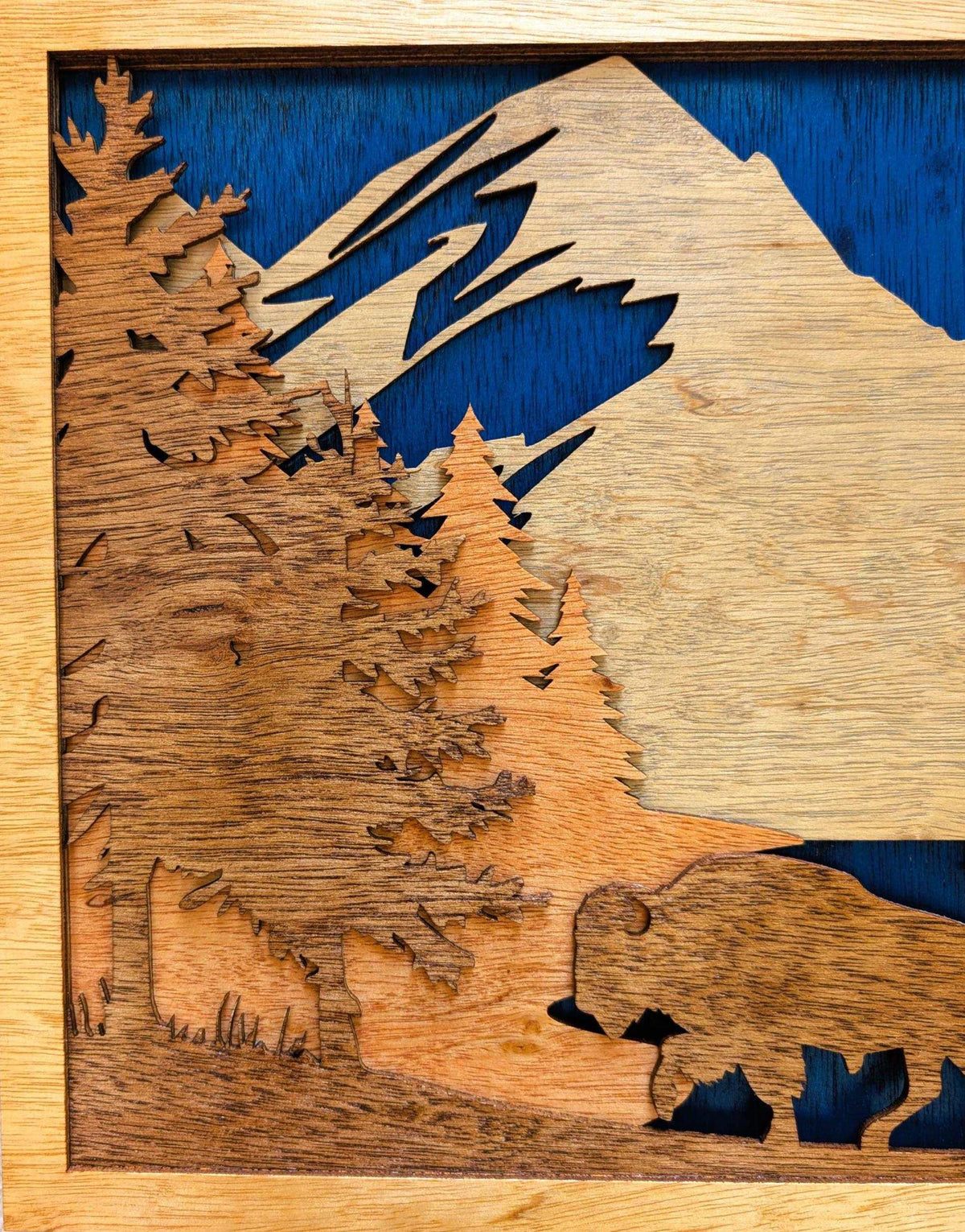 3D wood wall art featuring a layered Buffalo Mountain Scene with buffalo, mountains, evergreen forests, and lake in natural wood tones