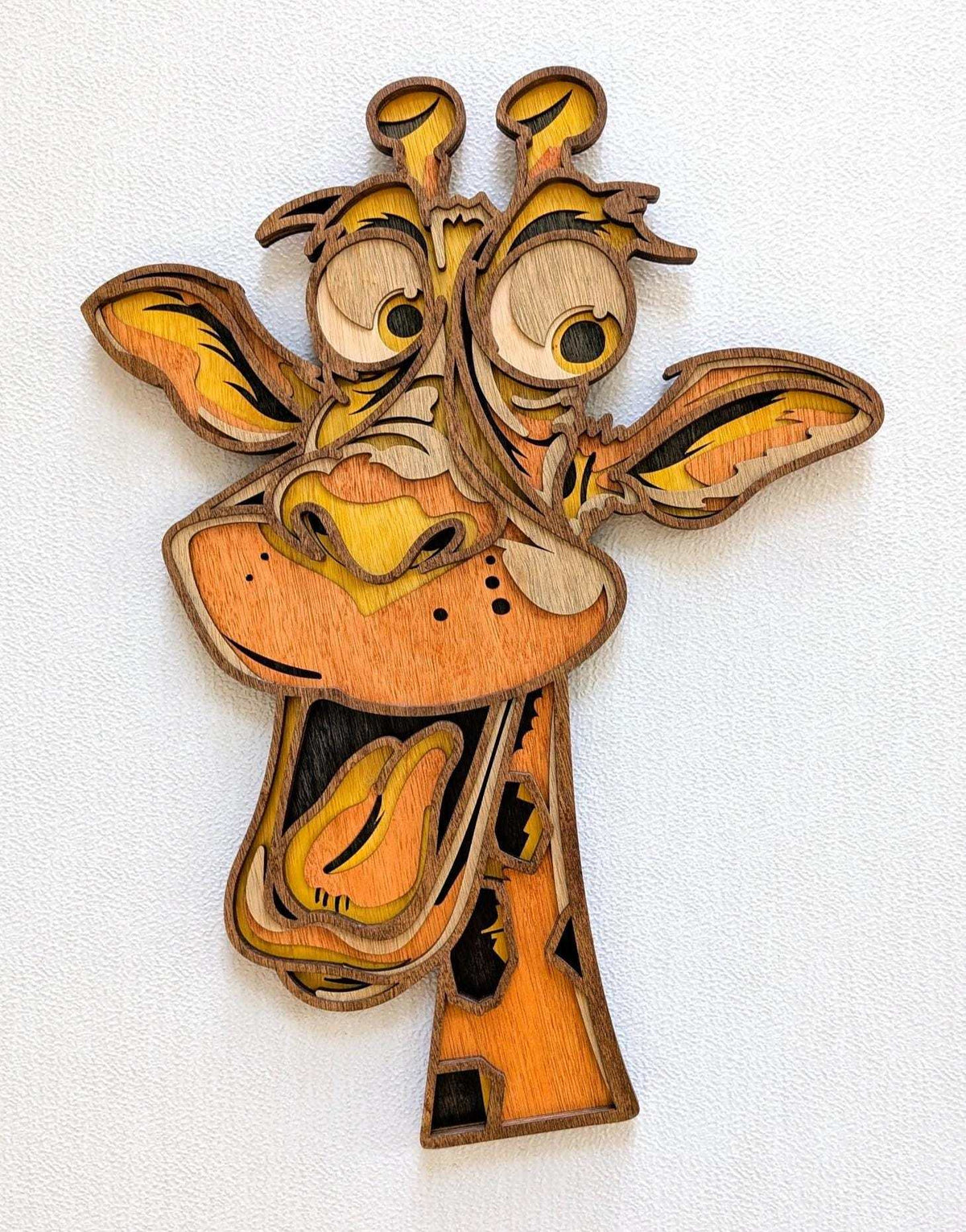 3D Fun Giraffe wood wall art with layered natural wood tones, orange muzzle, expressive eyes, and playful smile