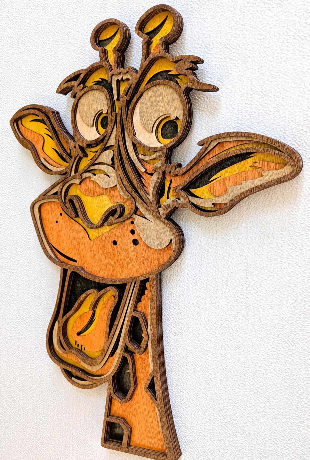 3D Fun Giraffe wood wall art with layered carved design, warm orange tones, oversized eyes, and playful expression