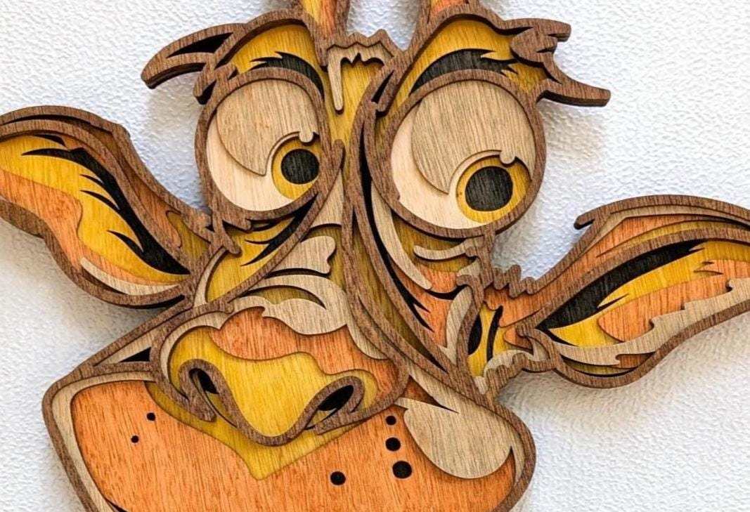 3D Fun Giraffe wood wall art with layered natural wood, yellow and orange tones, expressive eyes and a playful grin