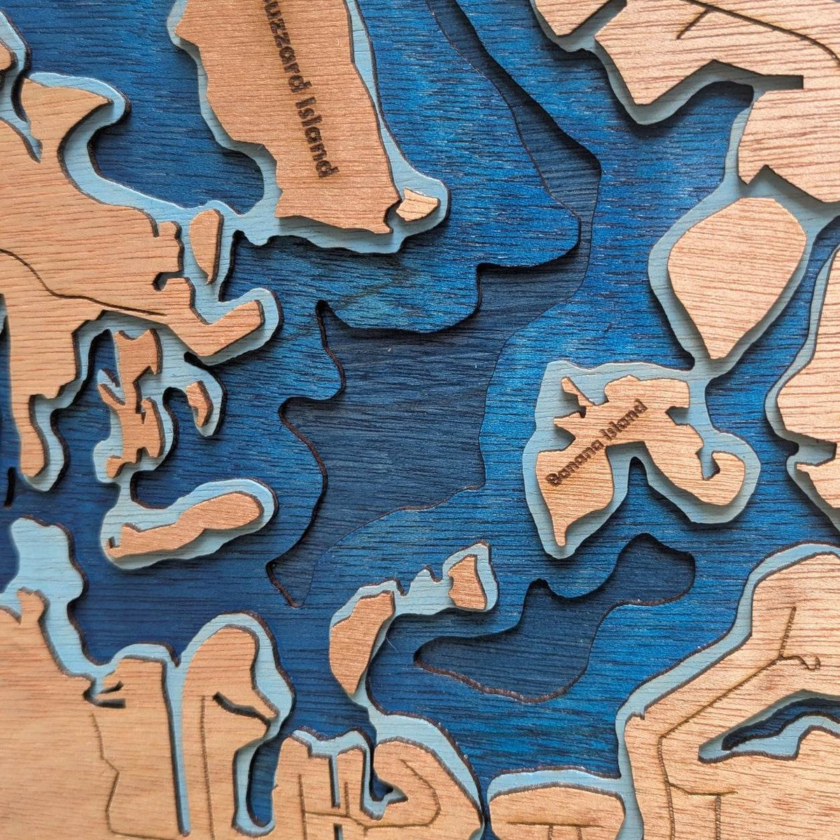 Layered blue marlin wall art depicting Kings Bay wood map