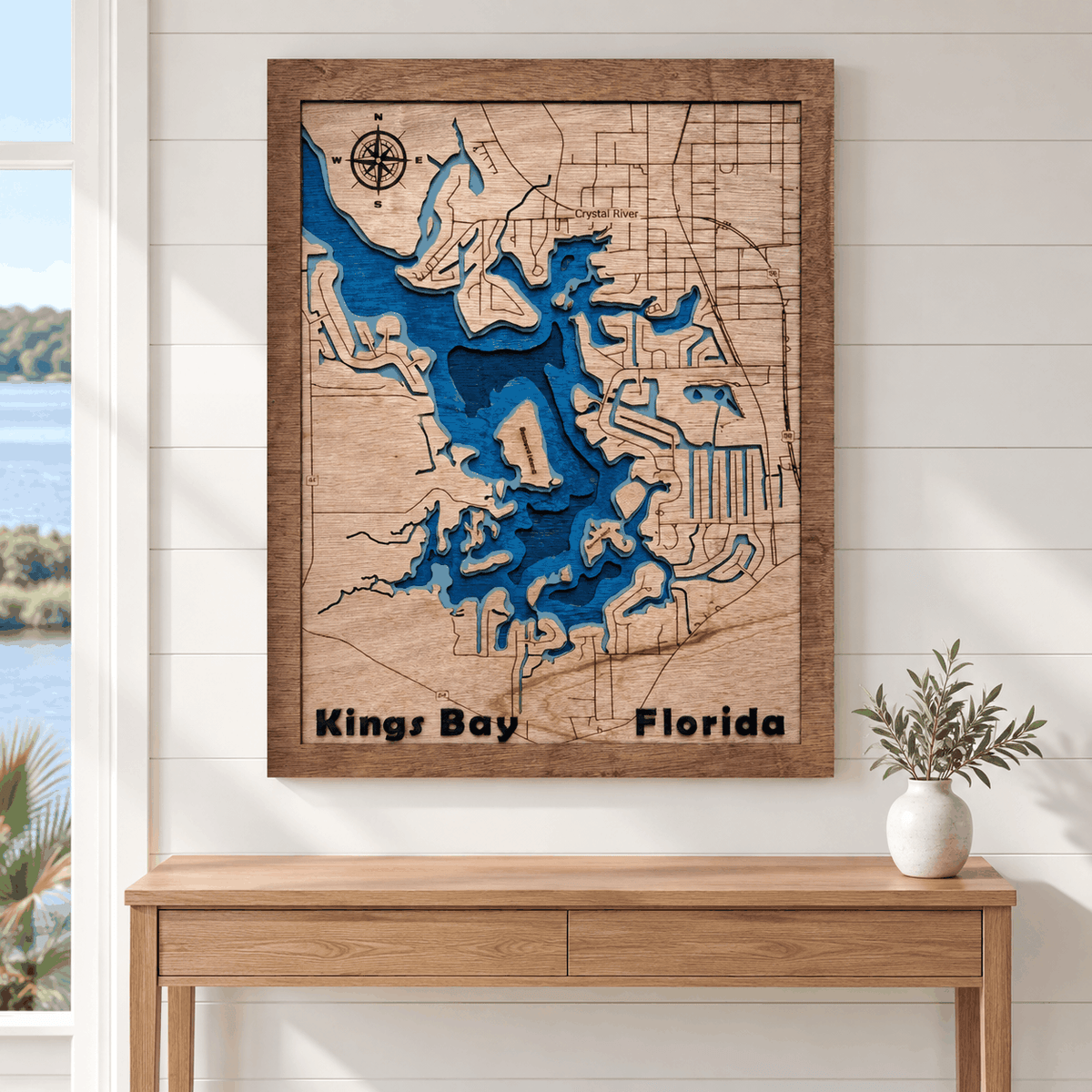 Layered wood map art of Kings Bay with blue waterways and natural wood tones