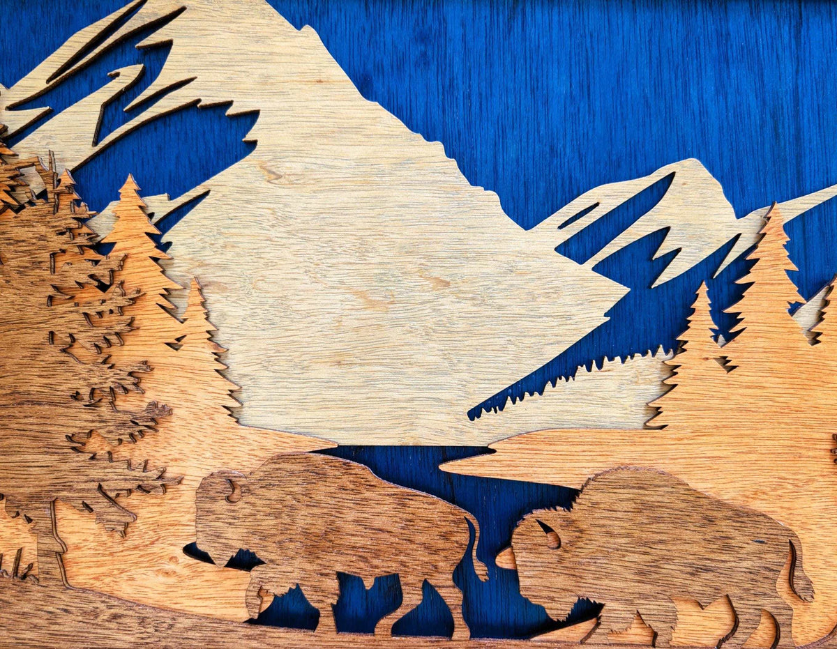 3D laser-cut wood wall art depicting buffalo in a mountain scene with forests and a lake