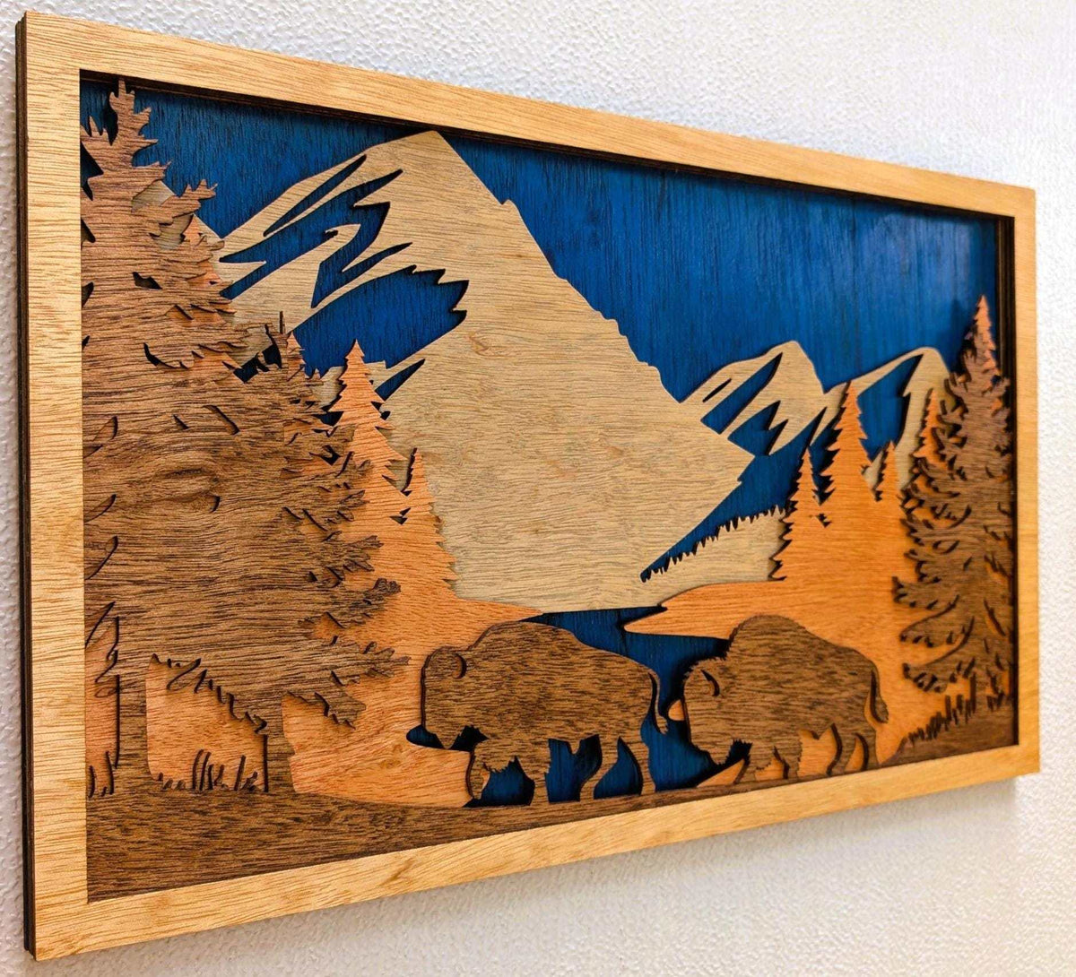 3D wood wall art featuring a layered Buffalo Mountain Scene with buffalo, mountains, pine trees, and a lake