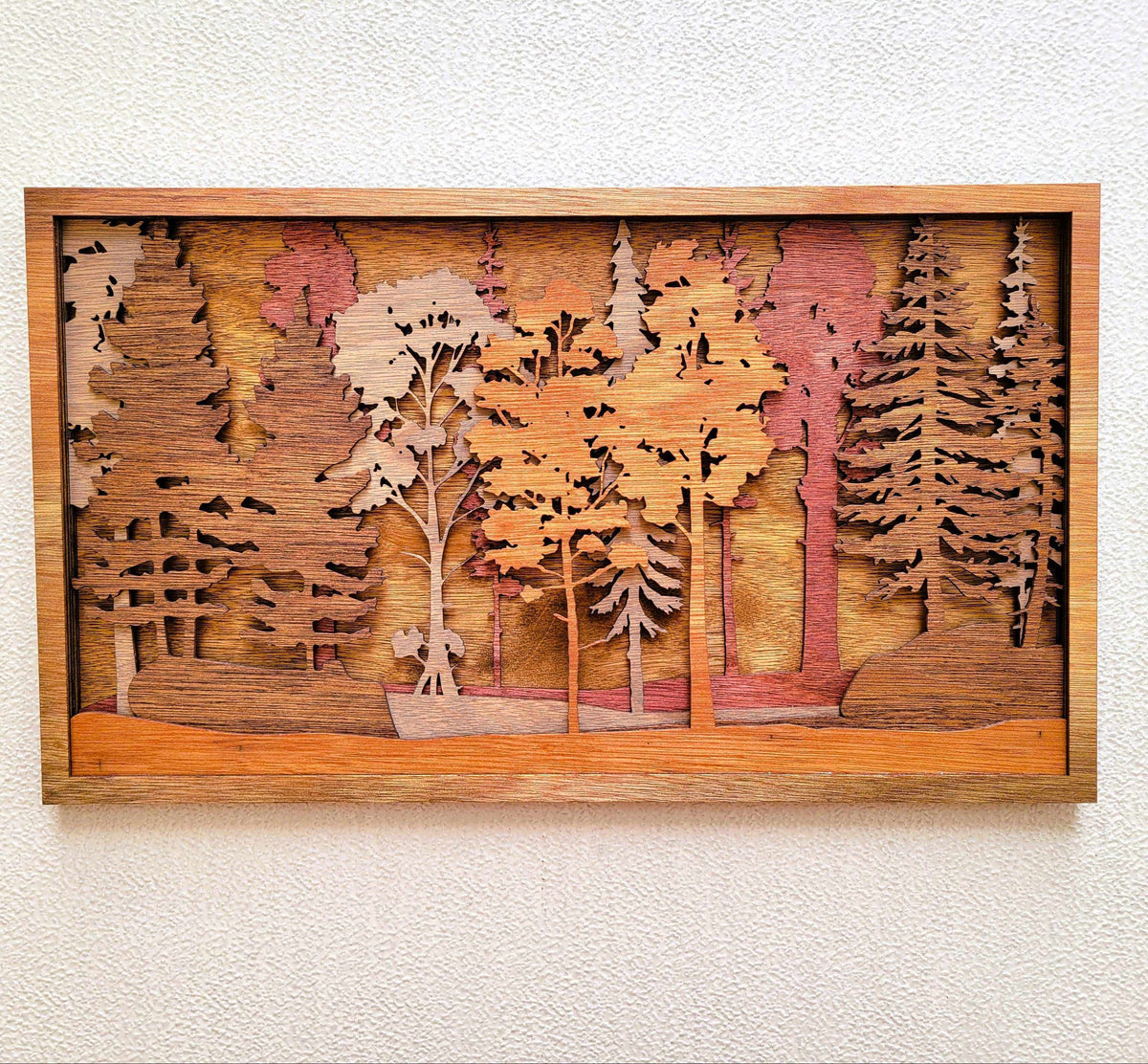 Forest Scene Layered Wood Wall Art in warm stained wood, featuring a dimensional woodland with layered pine and hardwood trees