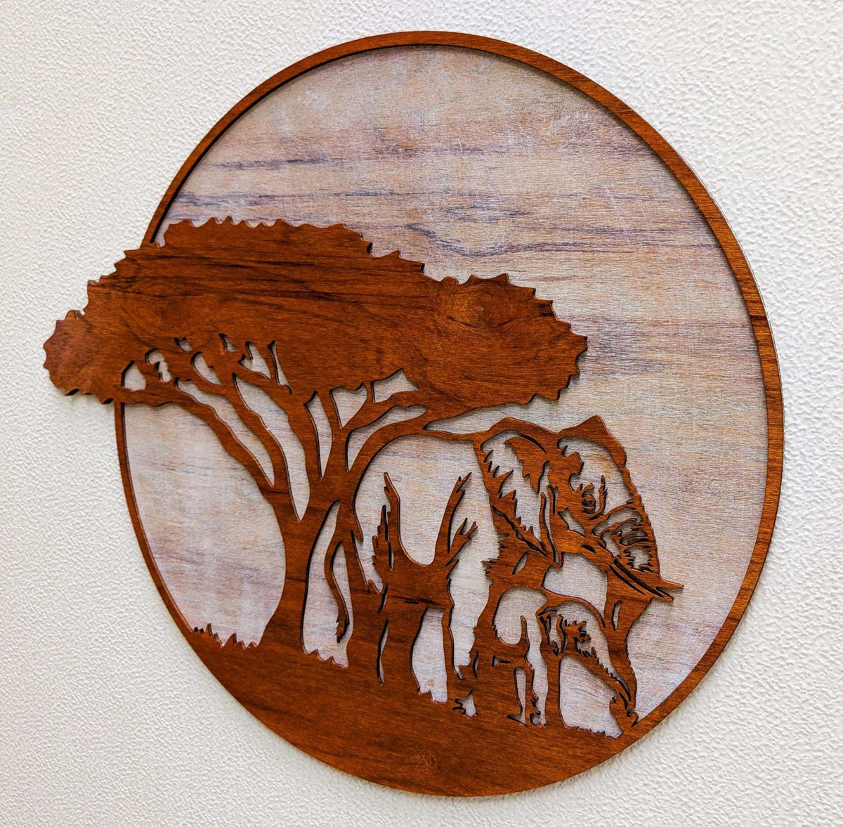 Handcrafted wooden jungle scene wall art featuring mama and baby elephants under an African acacia tree