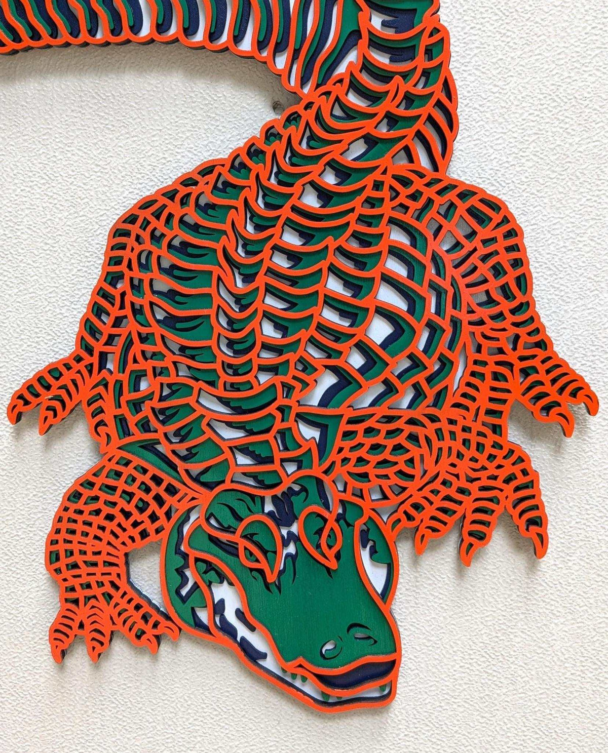 Layered Alligator Wall Art featuring a colorful green and navy alligator with orange laser-cut scales and layered wood depth