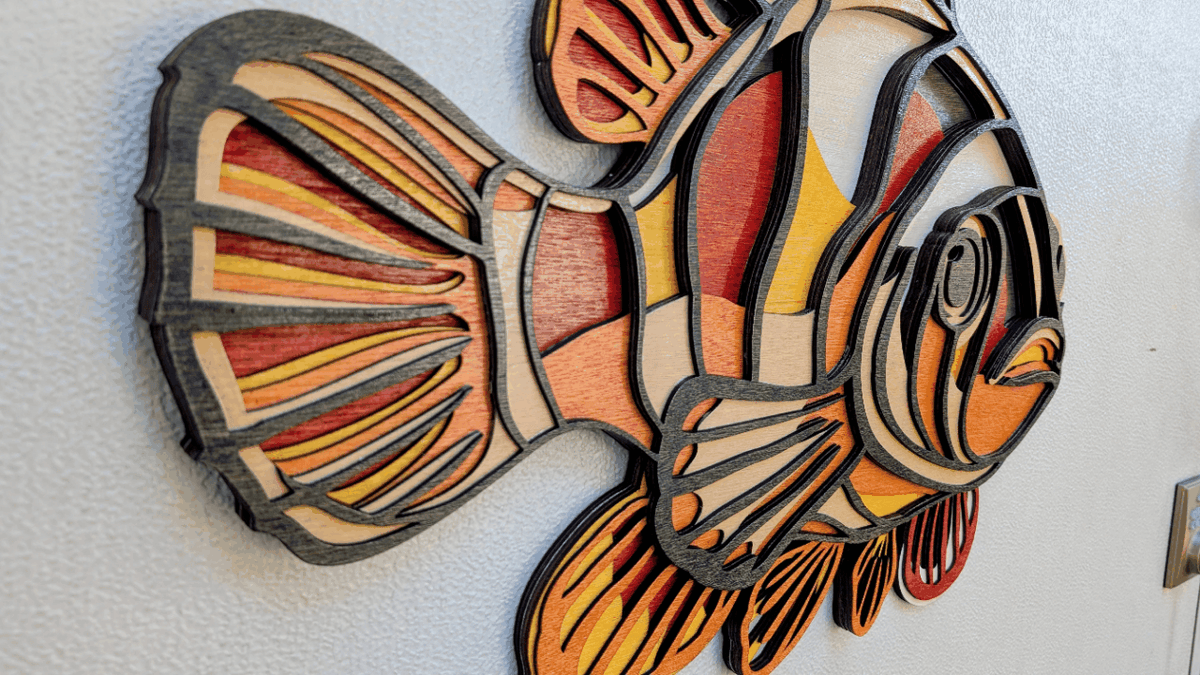 Handcrafted colorful layered clownfish wood wall art for coastal decor