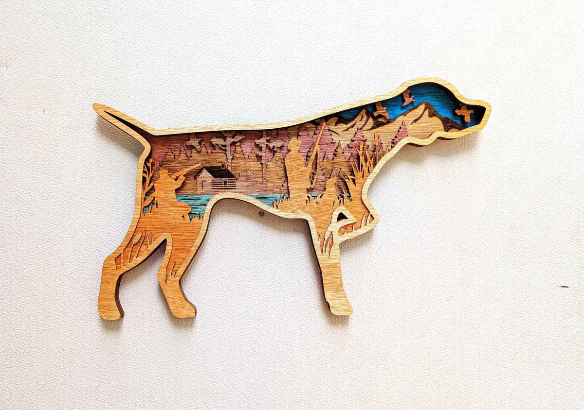 Layered Hunting Dog Wood Wall Art in warm stained wood, featuring a pointing dog silhouette with a colorful woodland scene