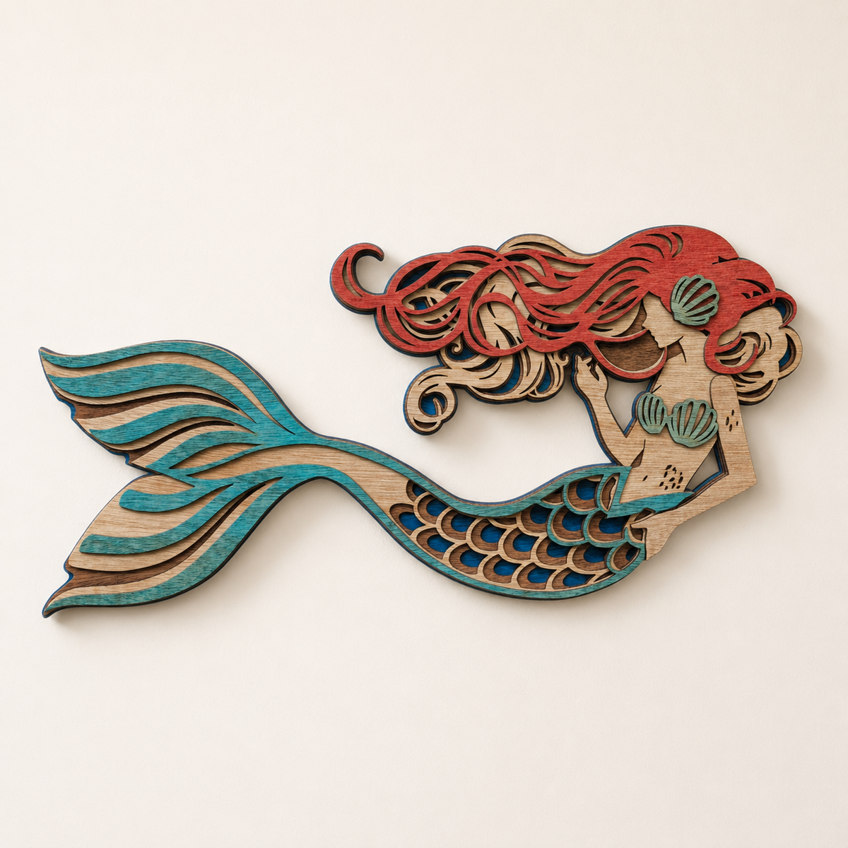 Layered coastal mermaid wood wall art with turquoise tail and coral hair
