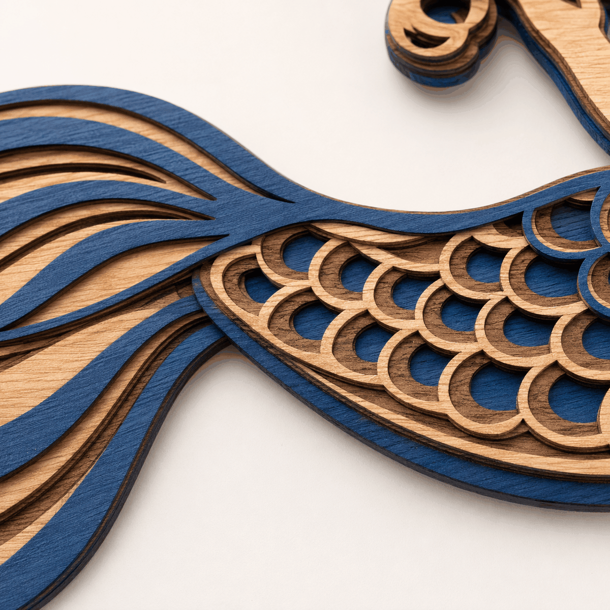Layered mermaid wood wall art with turquoise tail and coral-red hair