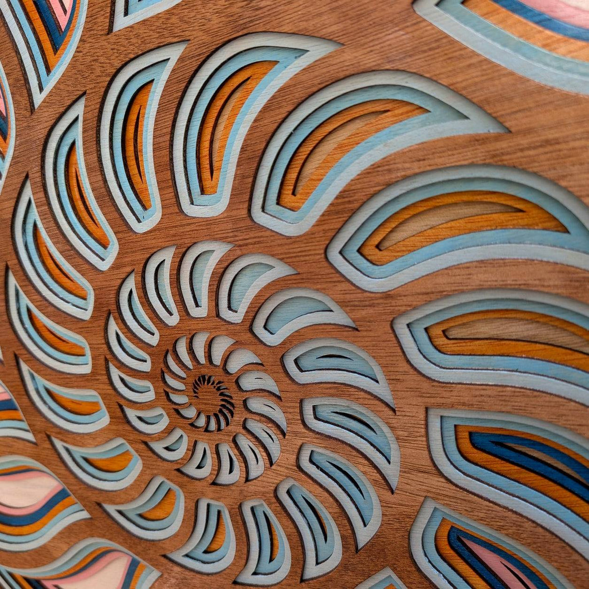 Handmade layered wood nautilus shell wall art with coastal ocean decor colors