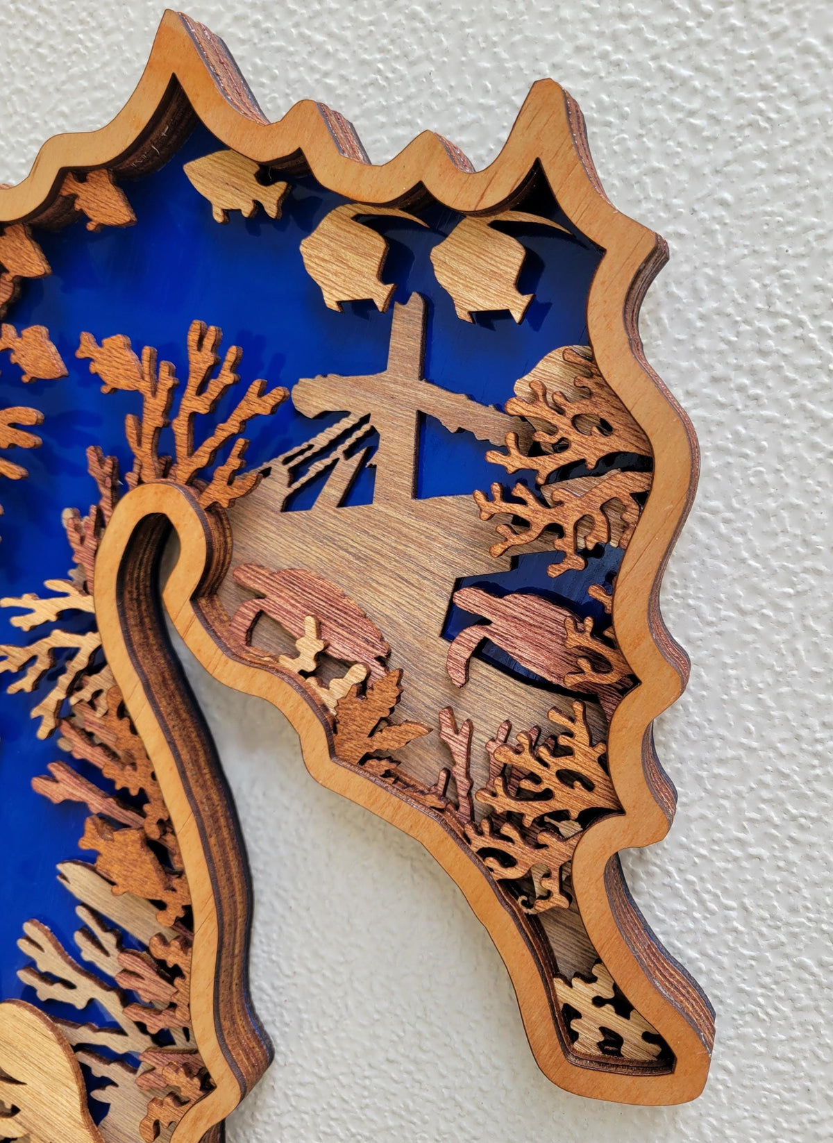 Layered Seahorse Wood Wall Art in blue and natural wood, featuring coral, fish, and intricate underwater details