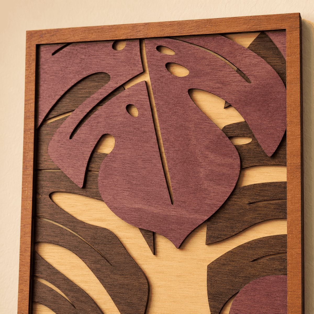 Layered Tropical Leaf wood wall art in burgundy, dark brown, and natural tones with raised monstera leaf layers