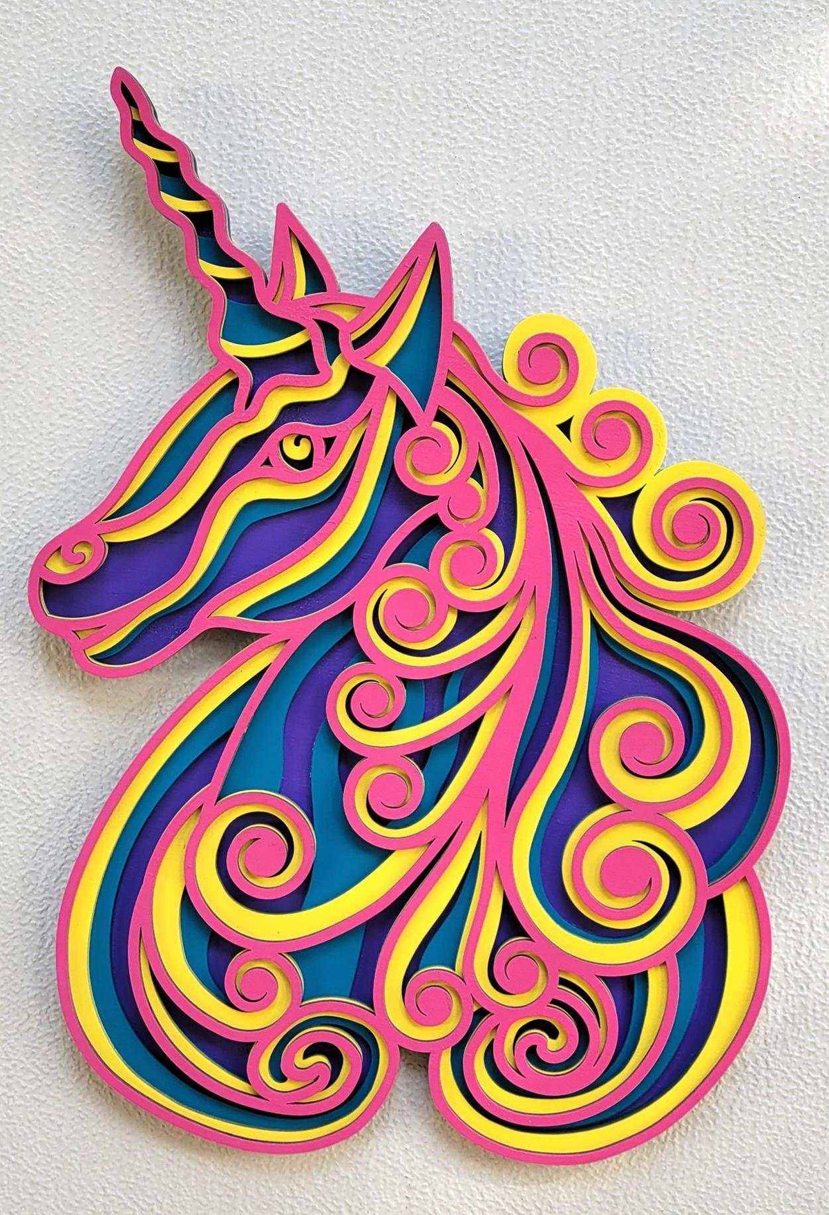 Layered Unicorn Wood Wall Art featuring a colorful pink, blue, purple and yellow unicorn with flowing mane curls